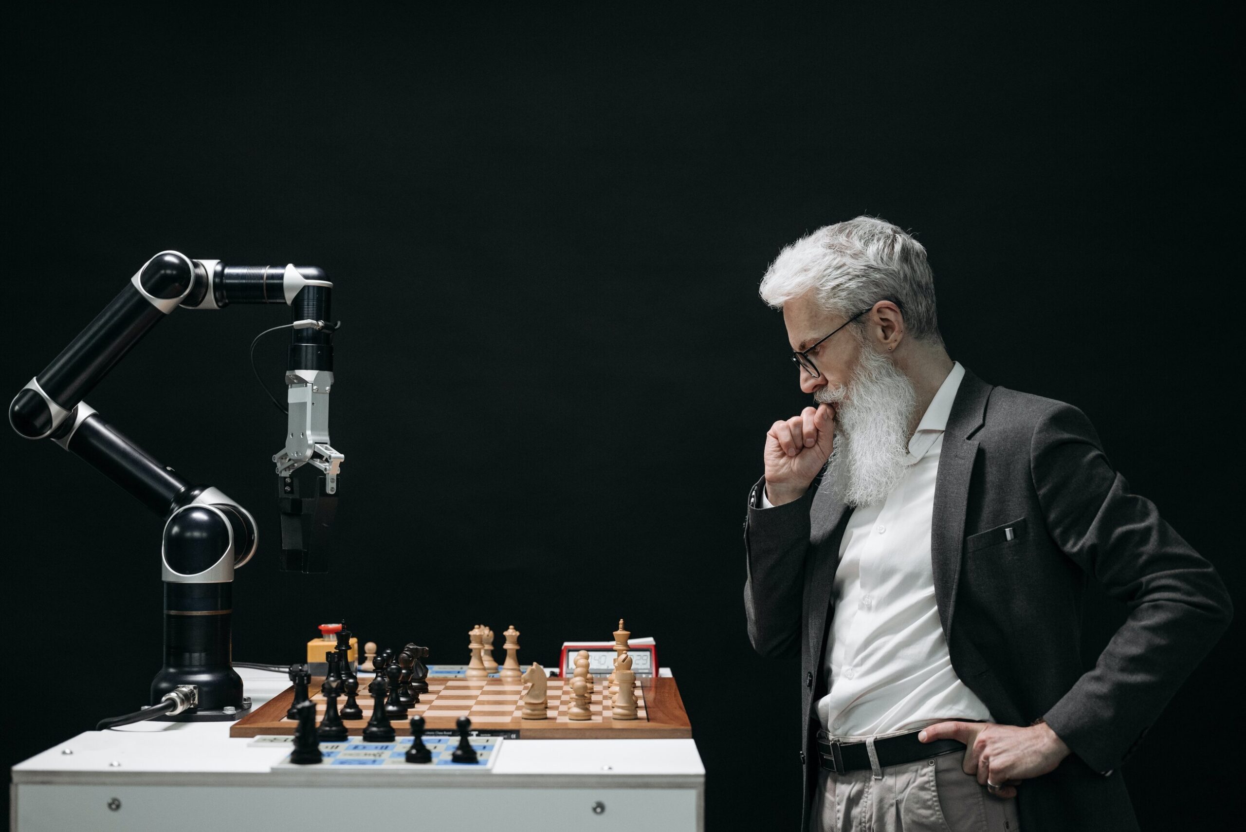 A picture of a robot playing chess with a human, depicting forex trading bots trading on behalf of humans 