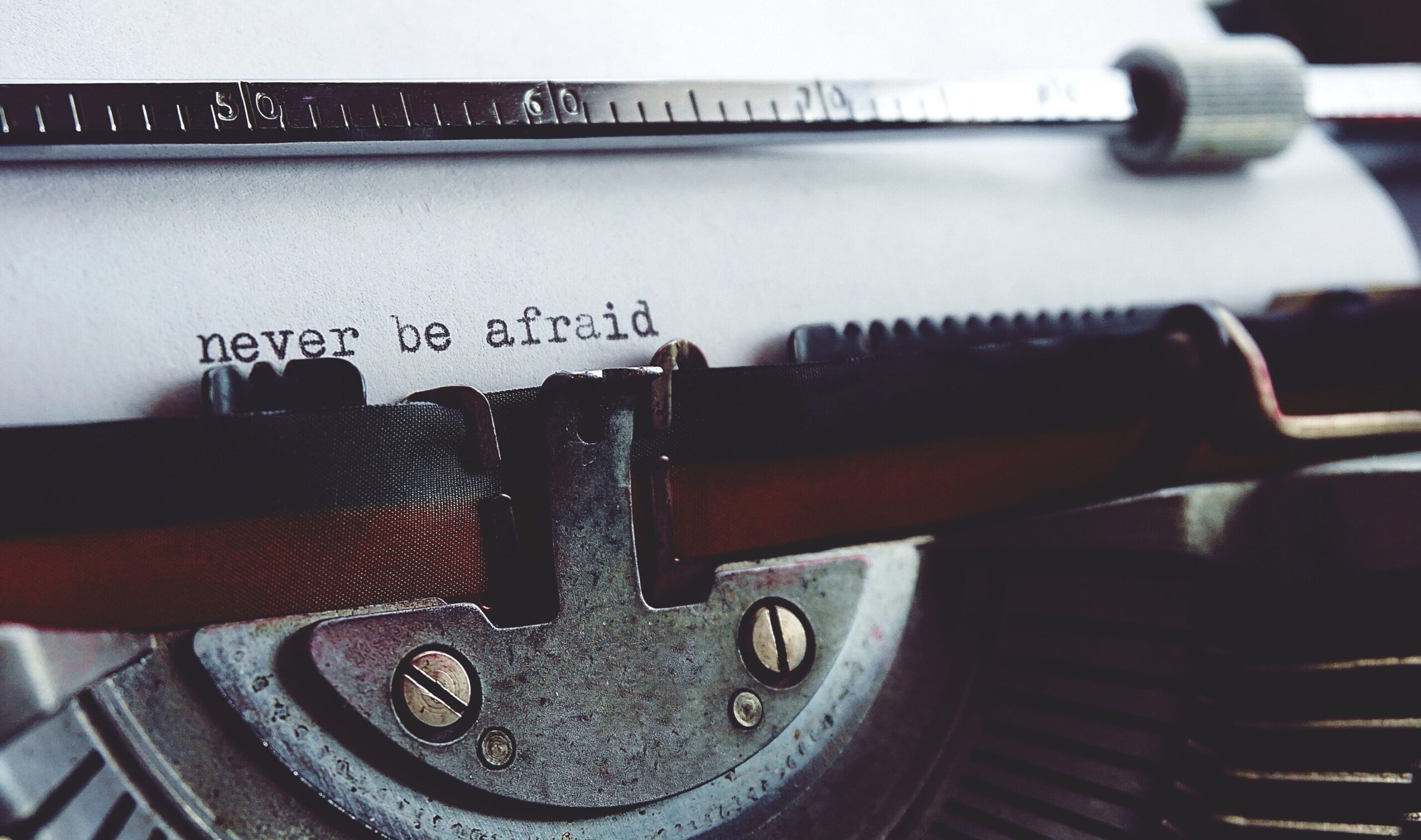 A quote: "Never be afraid" written by a typewriter machine